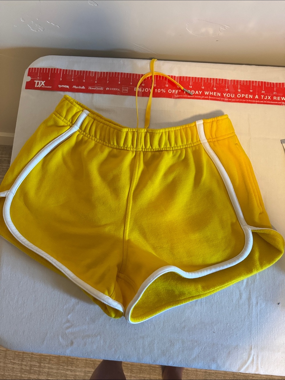 Lululemon yellow fleece lined shorts with side pockets and a drawstring waistban